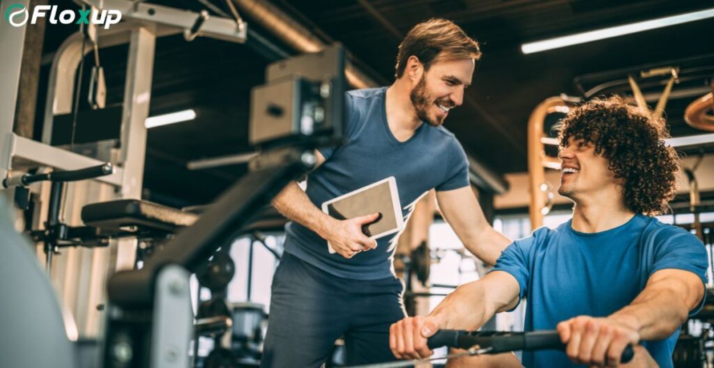 Partnership Marketing for Gyms – trainer guiding client during workout session in modern fitness center